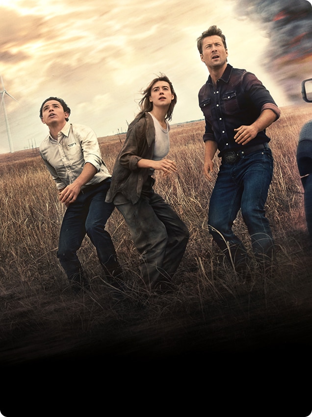Three people standing in a field