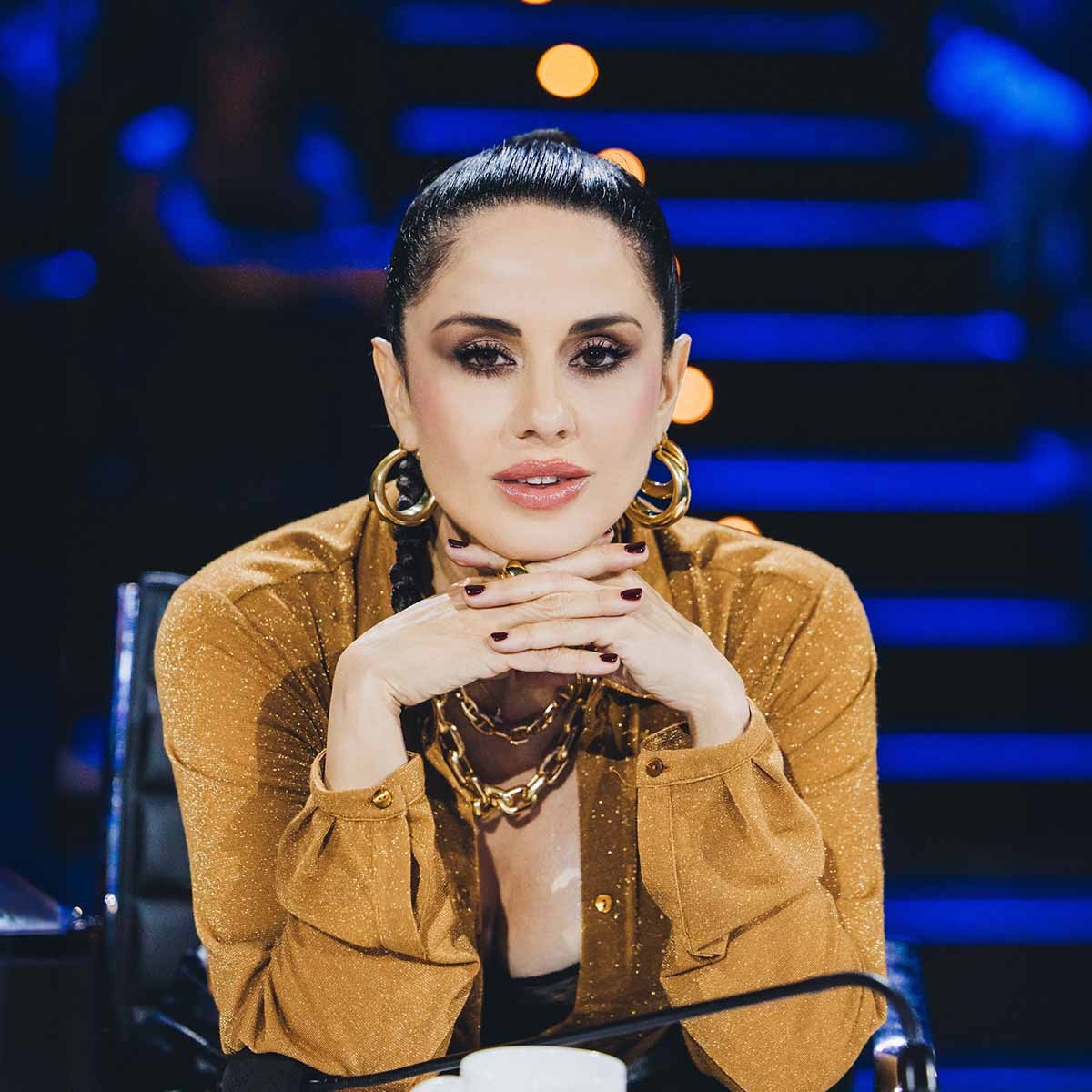 Paola Iezzi con abito dorato e orecchini grandi, seduta come giudice a X Factor 2024