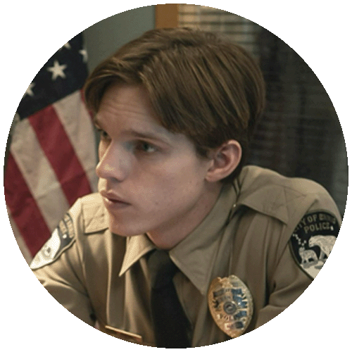 Finn Bennett in uniforme come Peter Prior, giovane agente di polizia in posa